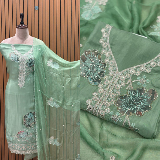 This elegant unstitched suit set features a rich organza fabric