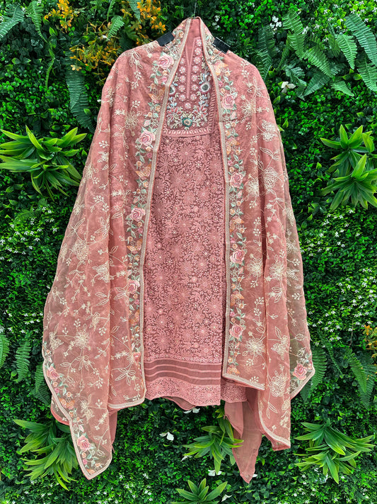Elegance with this premium unstitched suit set, featuring a pure Georgette top adorned