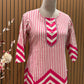 Vbrant pink and cream suit set features a stylish mix of vertical