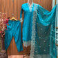 Stunning turquoise salwar suit features delicate white floral embroidery