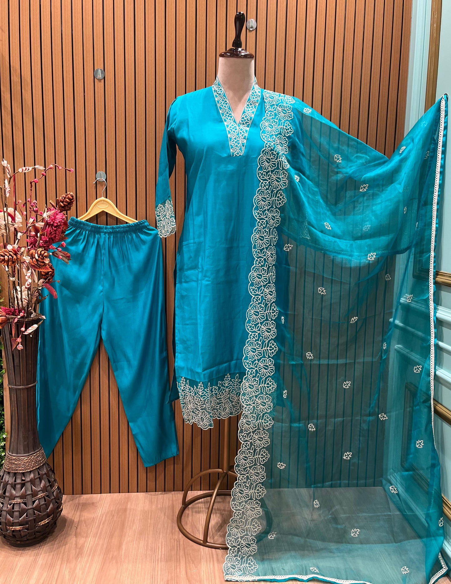 Stunning turquoise salwar suit features delicate white floral embroidery