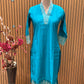Stunning turquoise salwar suit features delicate white floral embroidery