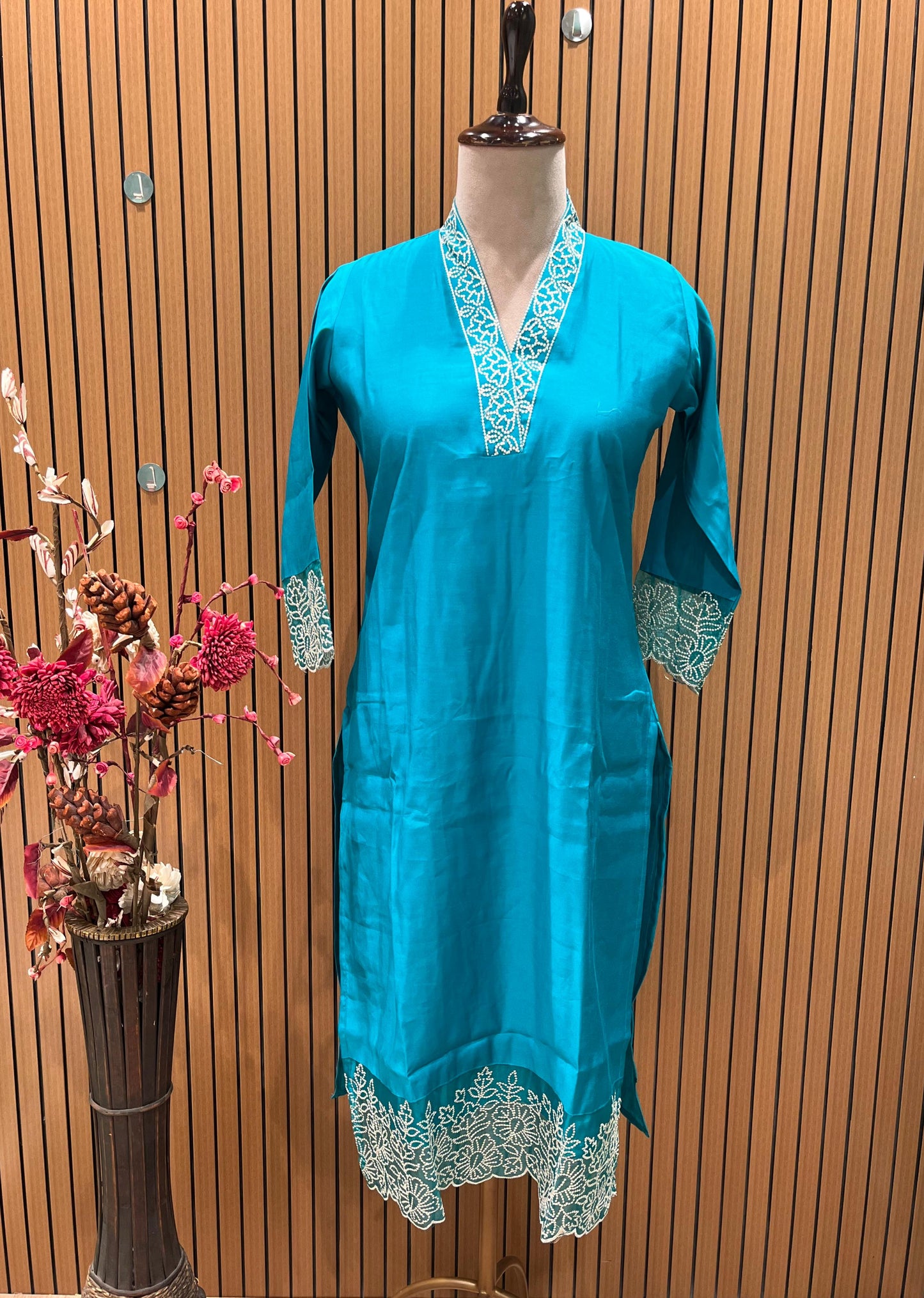 Stunning turquoise salwar suit features delicate white floral embroidery