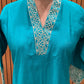 Stunning turquoise salwar suit features delicate white floral embroidery
