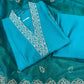 Stunning turquoise salwar suit features delicate white floral embroidery