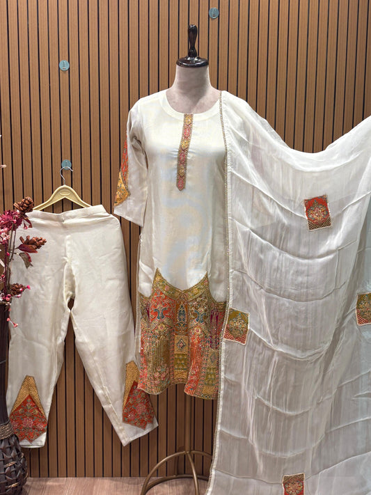 Exude regal charm in this exquisite ivory silk suit set