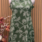 Sleeveless green flared dress with white swirl-leaf