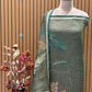 Unveil the charm of elegance with this olive green unstitched suit set