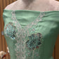 This elegant unstitched suit set features a rich organza fabric