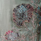 This elegant unstitched suit set features a rich organza fabric