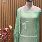 This elegant unstitched suit set features a rich organza fabric