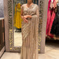 Gold shimmer soft-net saree featuring a stitched blouse