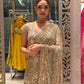 Gold shimmer soft-net saree featuring a stitched blouse