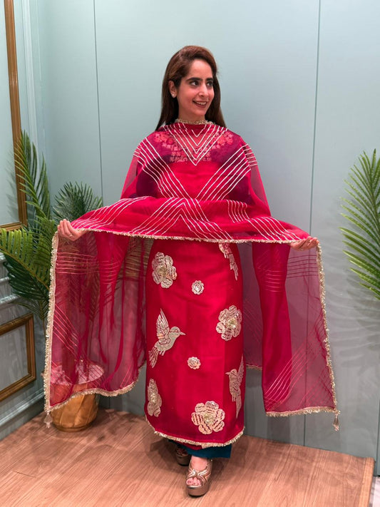 Crafted in organza shimmer fabric with rich gota patch work