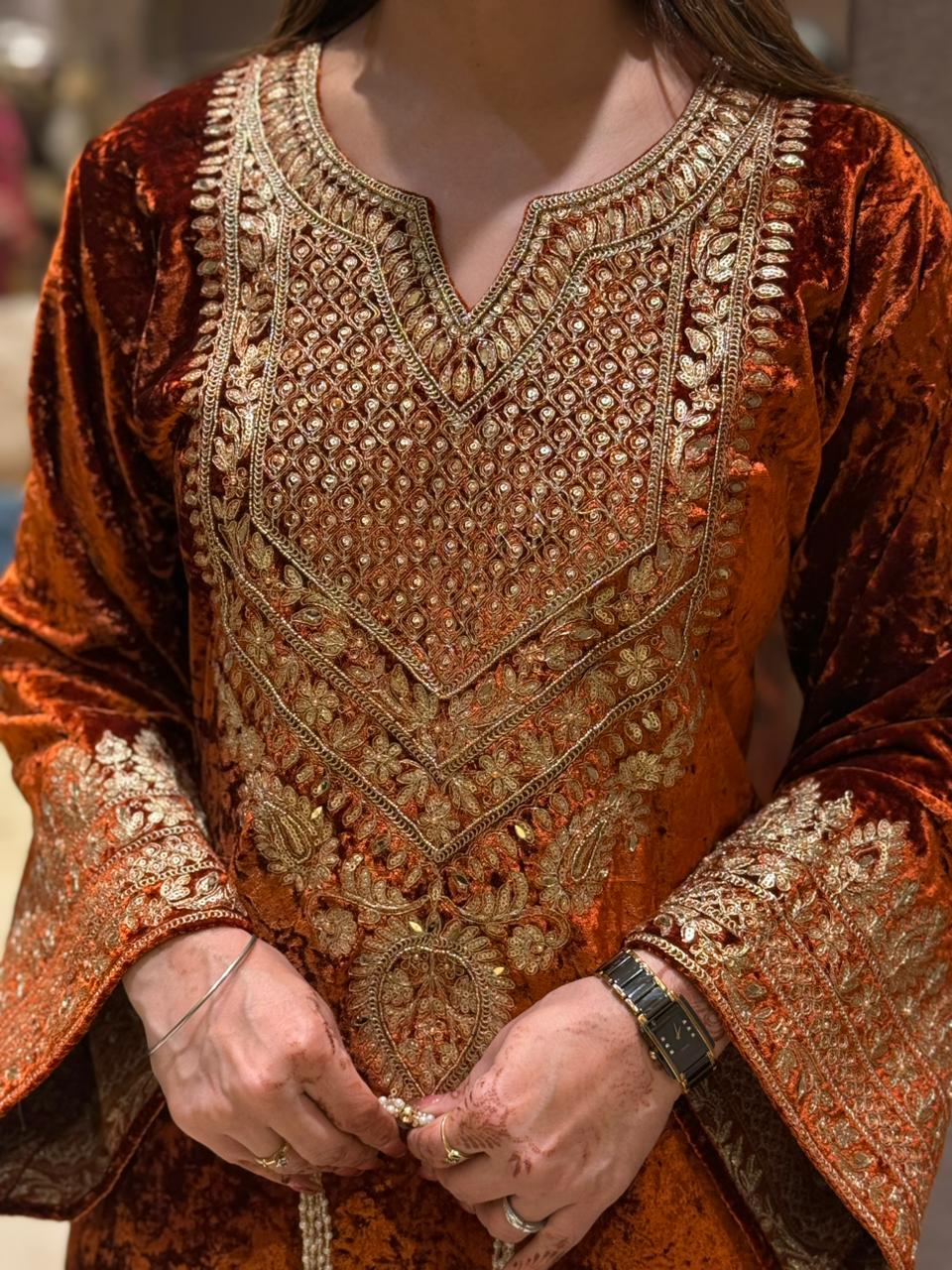 Royal velvet outfit with intricate golden embroidery and handcrafted potli bag