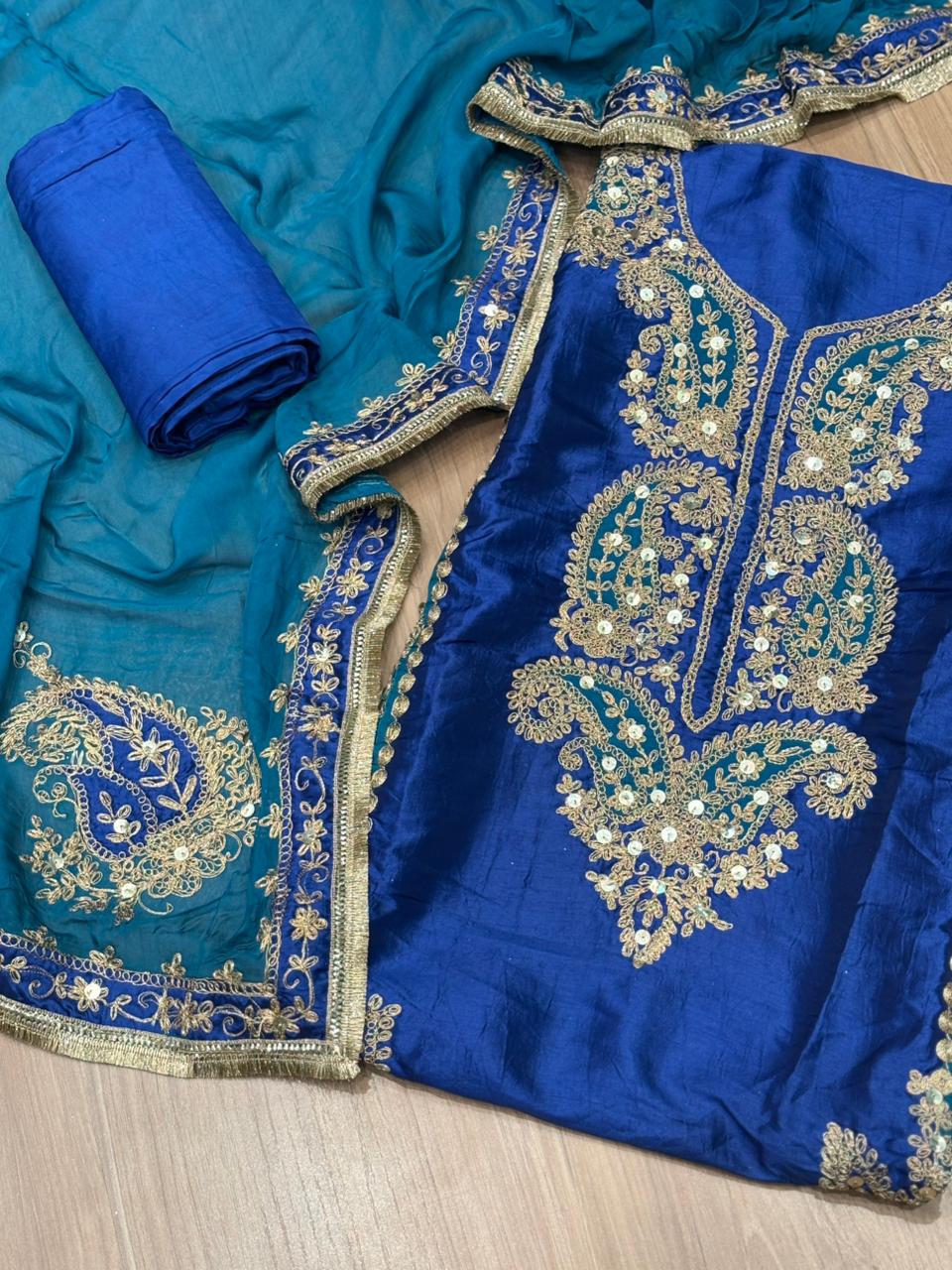 Elegant unstitched suit is crafted in rich silk fabric