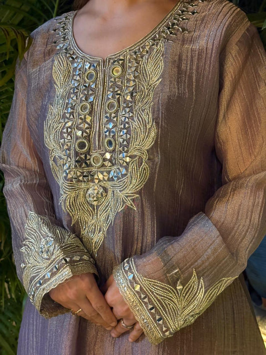 Graceful Anarkali set is crafted in luxurious tissue shimmer fabric