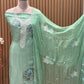 This elegant unstitched suit set features a rich organza fabric