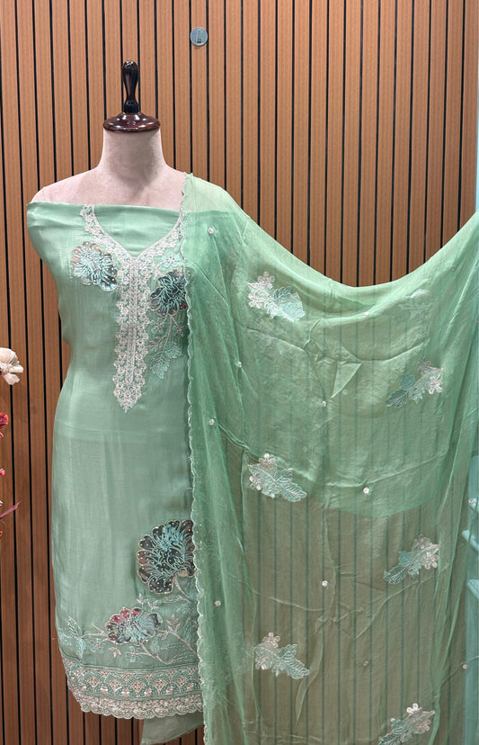 This elegant unstitched suit set features a rich organza fabric